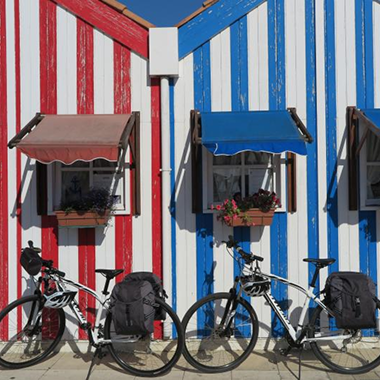 Bikes parked by colorful striped houses in Aveiro